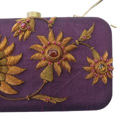 "Look your feminine best wearing this purple silk designer hard case clutch bag, hand embroidered with copper zardozi work flowers and embellished with genuine green onyx and agate gemstones. This is an eye-catching, sparkly, glittery purse, a classic design that never goes out of style. Expertly hand embroidered by third generation zardozi artisans. The word Zardozi means \"gold thread\". It is an elaborate and intricate multidimensional embroidery using metallic threads and genuine semi precio Designer Hand Embellished Gold Clutch, Gold Bag With Resham Embroidery For Reception, Party Potli Bag With Resham Embroidery, Rectangular Clutch With Resham Embroidery For Reception, Designer Gold Hand Embellished Clutch, Rectangular Clutch With Resham Embroidery, Gold Clutch With Resham Embroidery For Reception, Gold Clutch With Resham Embroidery For Evening, Formal Rectangular Bag With Resham Embroidery