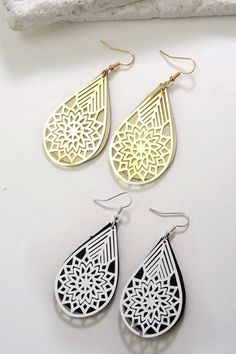 A unique filigree teardrop ear featuring high polish plating and faux leather accent.Length: 2" Laser Cut Teardrop Jewelry As A Gift, White Metal Teardrop Earrings, White Teardrop Earrings With Intricate Design, Black Laser Cut Jewelry, Sunglass Chain, Wall Accessories, Steel Necklace, Color Calibration, Monogram Initials