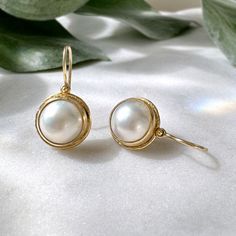 These simple and classic pearl drop earrings are perfect for everyday! Earrings feature beautiful mabè pearls set into a hammered bezel setting accented by dots. Process: Casting, Fabrication Materials: Solid 18K Yellow Gold, 11.3mm Fine Japanese Mabè Pearls with Mother of Pearl backing Size: 9/16" diameter Ships within 3-5 business days. Pretty Packages for Pretty Things Each piece ships in my custom packaging that is perfect for gift giving and safe keeping. Returns & Exchanges If for some reason a return or exchange is necessary, you have 7 days from the day you receive your package. Visit my policies page for more information. Classic Pearl Earrings, Lips Nails, Mabe Pearl, Jewelry Aesthetic, Pearl Set, Everyday Earrings, Custom Packaging, Contemporary Jewelry, Clothes Jewelry