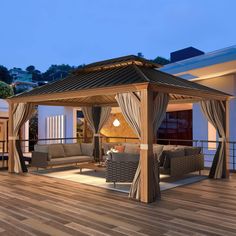 an outdoor living area with couches and a gazebo