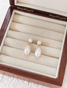 These timeless freshwater pearl drop earrings feature a classic design with a beautiful elongated pearl at the bottom and a smaller pearl at the top. The combination of these two pearls creates a sophisticated and elegant look, capturing a sense of refined grace. Perfect for any occasion, these earrings offer a super classic and enduring style that will remain a cherished accessory for years to come. Pearl size: Top pearl: 5 x 5 mm Bottom pearl: 9 x 11 mm Earrings size: 9 mm in length, 23 mm in Classic Teardrop Pearl Earrings For Everyday, Classic Teardrop Pearl Earrings For Everyday Elegance, Timeless Teardrop Pearl Pendant Earrings, Everyday Classic Teardrop Pearl Earrings, Classic Pearl Drop Pearl Earrings, Timeless Teardrop Pearl Earrings, Timeless Pearl Drop Earrings For Gift, Classic Pearl Earrings With Pearl Pendant, Classic Teardrop Pearl Earrings With Pearl Pendant