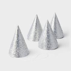 three silver glitter party hats on a white background with a cord attached to the top