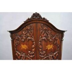 an ornate wooden headboard with carvings on it