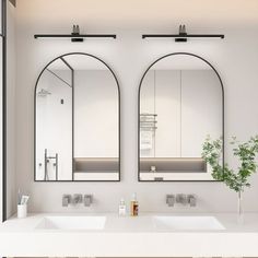 a bathroom with two sinks and mirrors on the wall