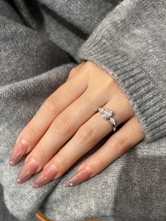 a woman's hand wearing a diamond ring