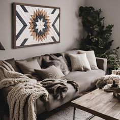 a living room filled with furniture and a large star painting on the wall above it