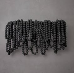 a group of black balls sitting on top of a gray floor next to each other