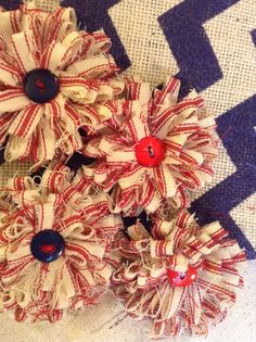 three red and white hair clips with buttons