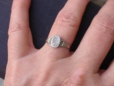 Art Deco Signet Ring.  This cute lady is 10k white gold and weighs 1.3.  Her center oval measures 8mm north to south and is engraved with the letters P C U...could be initials or possibly a University ring.  She is right at a size 5 3/4 and has a cut band which I have left as found for future possible sizing and is an easy fix by your local jeweler.   All items are in previously loved, used condition so please review all photos closely and let me know if you have any questions prior to purchasin Dainty White Gold Jewelry With Engraving Option, White Signet Wedding Ring With Round Band, White Signet Ring With Round Band For Wedding, White Wedding Signet Ring, Victorian Silver Signet Ring Stamped 14k, White Sterling Silver Engraved Signet Ring, Dainty Engraved White Gold Ring Stamped 14k, White Sterling Silver Signet Ring For Wedding, Wedding White Sterling Silver Signet Ring