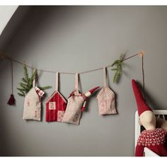 christmas stockings hung on a clothes line with santa's hat hanging from the pegs