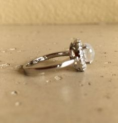 a diamond ring sitting on top of a counter