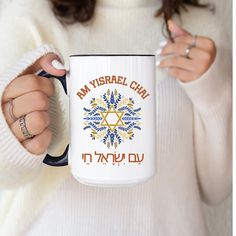 a woman holding a coffee mug with the words am visrall cha on it