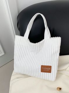 Add a touch of sophistication and functionality to your wardrobe with our Style Corduroy Tote Bag. Combining chic design with spacious interior, this bag is perfect for all your daily essentials. Its casual style makes it versatile for any occasion. Elevate your fashion game with this must-have accessory. Color : White Strap Type : Double Handle Style : Preppy Bag Size : Small Type : Shoulder Tote Bag Pattern Type : Plain Closure Type : Magnet Magnetic : Yes Material : Canvas Composition : 100% Linen Bag Height Bag Length Bag Width 23 32 7 White Cotton Shoulder Bag For Errands, Spring Cotton Bags For Errands, Trendy Corduroy Canvas Bag For Daily Use, Chic Cotton Bag With Large Capacity, Corduroy Bags With Zipper Closure, Chic Large Capacity Cotton Bag, Trendy Everyday Corduroy Bag, Trendy Corduroy Everyday Bag, Chic Cotton Shoulder Bag With Double Handle