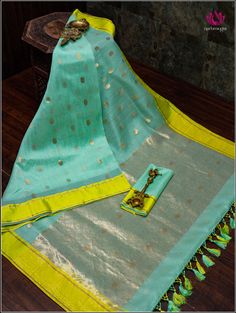 Chanderi saree in teal green with neon green border is a stunning combination. Teal green is a rich, elegant color that complements various skin tones, and the golden buttas spread across the body add a touch of traditional opulence. The neon green border provides a striking contrast, infusing a modern and vibrant feel into the classic Chanderi weave. Overall, this saree is a unique blend of classic craftsmanship and contemporary aesthetics, perfect for special occasions or cultural events. Fall and Pico - Done. Blouse - Unstitched. Custom fancy tassels. Please note: Color may vary slightly from the picture. Thread knots, thread pulls and minor inconsistencies are characteristic in Natural fiber sarees like cotton and it is not a defect. Green Tussar Silk Traditional Wear With Cutdana, Green Chanderi Saree With Zari Work, Green Tussar Silk Traditional Wear With Dupatta, Green Traditional Wear With Zari Work For Festivals, Festive Green Designer Saree, Designer Green Art Silk Saree, Turquoise Saree With Zari Work For Puja, Green Self Design Tissue Silk Dupatta, Festive Green Tussar Silk Traditional Wear