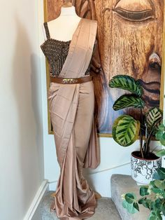 "!! Designer Collection!! Beautiful ready to wear 1 min saree with hand embroidered blouse and Sabyasachi style brown belt. Pre drapped sari.Perfect outfit for Asian wedding haldi ceremonies or festivals. It is very comfortable and light weight yet stylish and elegant. Details Blouse Fabric: Satin Silk Inner : Padded and Crepe lined Colour: Brown Sleeves: Strapes, extra net cloth provided for sleeves Embroidery : Beads and stone embroidery Saree Fabric: Satin Silk Inner : Crepe lined Colour : Pastel Brown Design: Ready to wear, pre drapped Belt: Brown leather belt with buckle Size Available : M,L Care instructions: Dry Clean Please note: Only brown belt is available. Please drop us message if you need any more details. Thanks" Silk Saree With Belt Style, Saree With Sabyasachi Belt, Saree With Belt Style, Sarees With Belt Style, Silk Saree With Belt, Sabyasachi Belt, Marron Pastel, Pre Pleated Saree, Pastel Saree