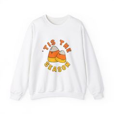 Nothing spooky here. This Halloween Candy Corn Lover Crewneck Sweater is the perfect cute fall pullover. Wear it out Trick or Treating or to the pumpkin patch! Cooler autumn temps have nothing on this long-sleeve crew sweater. It's the perfect fall sweater for her. PRODUCT DETAILS: Gildan 18000 crew neck Sweatshirt Made with a medium-heavy fabric blend of 50% cotton and 50% polyester (8.0 oz/yd² (271.25 g/m this sweatshirt feels cozy and is the perfect choice for those colder months. The classic fit along with the crew neckline deliver a comfy wearing experience with a clean-cut style. Meanwhile, the double-needle stitching at the shoulder, armhole, neck, waistband, and cuff seams add top-tier durability. Say goodbye to itchiness thanks to the gray, pearlized tear-away label. Made using 10 Fall Pullover, Patches Shirt, Fall Gifts, Cute Pumpkin, Fall Sweaters, Fall Fun, Pumpkin Patch, Cut And Style, Crew Neck Sweater