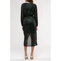 Introducing the August Sky Women's Sequin Faux Wrap Midi Dress, your ultimate party companion for ringing in the New Year or dazzling at any formal event. This dress features a captivating V-neckline with a hidden snap closure, adding an element of allure to your look. With elastic around the waistline, it guarantees a comfortable and flattering fit, while the long sheer puff sleeves, adorned with elastic openings, exude a touch of glamour. A faux tie around the waistline adds a hint of playfulness. Lined to perfection to prevent any sheerness, this dress showcases an alluring tulip hemline. Embrace the spotlight with this shimmering sequin ensemble that's bound to steal the show wherever you go. Green Sequin Dress For Holiday Party, Green Sequin Dress For Holiday Night Out, Elegant Green Sequin Dress For Holiday Party, Green Sequin Dress For Night Out, Green Sequin Dress For Night Out Party, Glitter Sequin Dress For Night Out In Fall, Green Sequin Dress For Date Night, Fall Sequin Dress With Glitter For Night Out, Festive Green Sequin Dress For Party