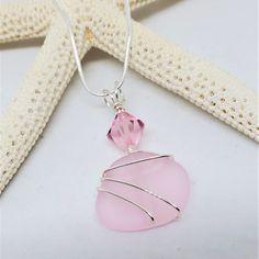 "Sea Glass Jewelry - Seaglass \"Birthstone\" Necklace, Pendant for coastal, beach, ocean lovers. Cultured sea glass, beach glass. Soft PINK freeform cultured sea glass custom hand-wrapped with silver plated wire. Complimenting large OCTOBER Pink Swarovski Crystal. Pendant length approximately 1 3/4 inches. Silver plated 18\" chain included. Nickel Free. Handmade in the USA. \"Cultured\"Sea Glass is eco-friendly sea glass, beach glass made from recycled glass. Re-purposing glass into something be Clear Sea Glass Jewelry For Gifts, Clear Sea Glass Jewelry Gift, Clear Sea Glass Jewelry For Gift, Beach Pendant Jewelry With Recycled Glass, Beach Wire Wrapped Glass Jewelry, Clear Glass Jewelry For Beach, October Pink, October Birthstone Necklace, Swarovski Pendant