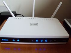 a white router sitting on top of a wooden table