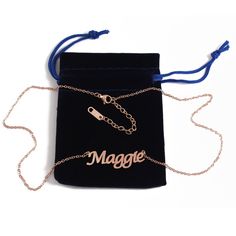 a black velvet bag with the word maggoe on it and a chain attached to it