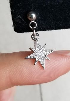 The star charm is real platinum plated with real cubic zirconia gems embedded! I've been so excited to share this one, it's one of my absolute favorite earrings!This is not an exact replica, it is simply an inspired endeavor to show my appreciation for BTS's taste in accessories. I use stainless steel posts and hypoallergenic chains and findings. I'm very careful to source my materials from trusted suppliers, in order to provide high quality and affordable earrings. The earring is quite light an Cubic Zirconia Star Charm Dangle Jewelry, Cubic Zirconia Dangle Jewelry With Star Charm, Diamond White Star-shaped Cubic Zirconia Jewelry, Dazzling Star-shaped Cubic Zirconia Jewelry, Diamond White Cubic Zirconia Star Jewelry, Cubic Zirconia Drop Earrings With Star Charm, Star-shaped Cubic Zirconia Earrings With Star Charm, Silver Star-shaped Jewelry With Sparkling Stones, Star-shaped Cubic Zirconia Jewelry With Sparkling Stones