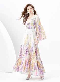 "Blossoming with the vibrant vitality of spring, this enchanting dress encapsulates the essence of a serene garden in full bloom. It’s a poetic sartorial choice for the romantic at heart, featuring a soft, flowing fabric adorned with delicate floral prints in a symphony of lilac, yellow, and pink hues. The deep V-neckline exudes a hint of allure, balanced by the full-length bishop sleeves that add a touch of bohemian elegance. Each tier of the skirt cascades gently to the ground, creating a silh Spring Wedding A-line Chiffon Dress, Spring Feminine A-line Chiffon Dress, Flowy Chiffon Dress For Spring Wedding, Spring Wedding Flowy Chiffon Dress, Spring Bohemian Chiffon Dress For Weddings, Fitted Bohemian Chiffon Dress For Garden Party, Bohemian Fitted Chiffon Dress For Garden Party, Spring Wedding Chiffon Dress With Floral Print, Elegant A-line Chiffon Dress For Spring