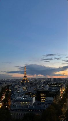 the eiffel tower is lit up at night