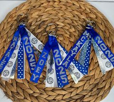 four blue and white ribbon lanyards in a woven basket