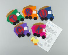 four felt trains with the letter c on them and a rubber duck next to it