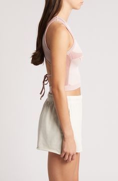 This cool cropped tank is crafted in a close-fitting silhouette with a tied-and-cutout back. 15" length (size Medium) Ties at back Crewneck Sleeveless 38% polyester, 35% recycled polyamide, 21% polyamide, 6% elastane Machine wash, line dry Made in Turkey Spring Athleisure Crop Top Tank, Spring Athleisure Crop Tank Top, Spring Cami Sports Bra With Seamless Construction, Seamless Tank Sports Bra For Spring, Sporty Crop Tank Top For Spring, Seamless Athleisure Crop Top For Summer, Spring Cami Sports Bra, Sporty Spring Crop Top Tank Top, Spring Sporty Crop Top With Tank Straps