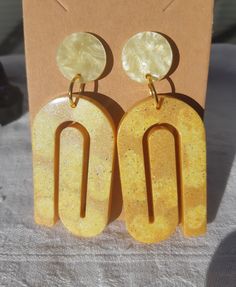 Large resin earrings in an art deco spiral shape. Tinted yellow and light orange. Light to wear despite the size. Handmade Retro Orange Earrings, Funky Handmade Yellow Earrings, Adjustable Artistic Yellow Earrings, Retro Yellow Dangle Earrings, Artistic Orange Earrings, Spiral Shape, Light Orange, Handmade Artisan, Artisan Jewelry