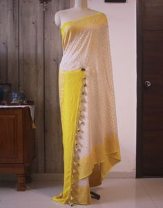 A White Yellow Banarasi Handloom Pure Khaddi Georgete Saree to make you stand out in a crowd. Furthermore, the saree is weaved all over with zari in a beautiful pattern. Thus, this saree is for those who love handloom and have a taste for traditional attire. Also, it comes with blouse piece. Note: Banarasi Khaddi Georgete is a very soft and drapy fabric. Additional Information Color : White Blouse Color: Yellow Zari Color: Golden Technique: Banarasi Cutwork Weaving Fabric: Pure Khaddi Georgete B Weaving Fabric, Peach And Green, Traditional Attire, Beautiful Saree, Cut Work, White Blouse, Blouse Piece, Beautiful Patterns, Pure Silk