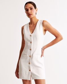 Elevate your wardrobe with the A&F Mara Vest Mini Dress, a chic ensemble perfect for any occasion. This dress features a flattering body-skimming silhouette crafted from premium crepe fabric. 

- Size: XL
- Color: Cream
- Material: Bodice lined with Polyester and Elastane
- Gender: Female
- Design: Features a button-through detail, non-functional front pockets, and a sleek v-neckline

Ideal for both daytime and evening wear, the Mara Vest Mini Dress combines functionality with fashion, ensuring Summer Workwear Mini Dress With Notched Neckline, Summer Mini Dress With Notched Neckline For Work, Chic Mini Dress With Pockets For Daywear, Elegant V-neck Mini Dress With Pockets, Fitted V-neck Dress With Pockets, Summer Workwear Dresses With Back Button Closure, Fitted V-neck Dress With Button Closure, Knee-length, Chic Unlined Mini Dress For Daywear, White V-neck Mini Dress With Button Closure