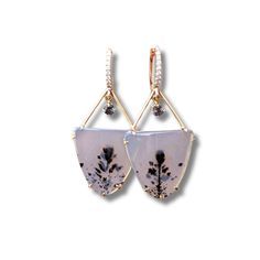 Handcrafted in 14K yellow gold and adorned with sparkling diamonds, these one-of-a-kind earrings showcase a mesmerizing pair of Montana Agates. These rare agates feature a preserved flower, frozen in time, while a grey spinel charm hangs delicately, adding a touch of movement and shimmer. Enclosing a timeless bloom, these earrings represent everlasting beauty and love. Elegant Dangle Earrings With Natural Inclusions, Elegant Chalcedony Drop Earrings, Elegant Chalcedony Earrings With Natural Stones, Elegant Agate Jewelry With Gemstone Accents, Elegant Chalcedony Jewelry With Gemstone Accents, Montana Agate, Frozen In Time, How To Preserve Flowers, Sparkle Diamonds