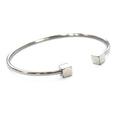 Gorgeous Rhodium plated steel bracelet with clean cubes at the handle. This bracelet compliments any wrist beautifully. The bracelet comes in two sizes but both are widely sizeable by pulling the string.Fit's up to a 7 inch wrist.