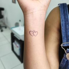 two hearts tattoo on the wrist