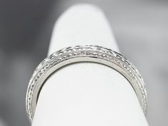 A beautiful platinum band for wearing as a wedding ring, this would make a great stacking ring, as well! The pattern is pretty, what we call a wheat pattern, and is classic for the era. Metal: Platinum Width of Band: 3.8 mm Height off Finger: 2.1 mm Ring Size: 6.50 Marks: "90% PLAT CTI" Stamped on the inside band Classic Stackable Rings With Prong Setting, Timeless Stackable Bands For Formal Occasions, Timeless Formal Stackable Bands, White Gold Heirloom Stackable Rings, Heirloom Style Stackable Eternity Band, Fine Jewelry Wedding Rings With Milgrain Detail, Heirloom Style Stackable Round Eternity Band, Heirloom Stackable Round Eternity Band, Classic Stackable Ring Bands