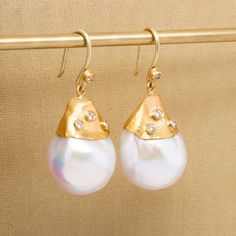 "Large, White, 54ct Baroque Pearl Earrings with Diamonds, in 24kt Gold by Prehistoric Works of Istanbul, Turkey. Length: 34mm (1.4\"); Width: 15.5mm (.6\"). Throughout the centuries, pearls have been associated with wealth, femininity, purity, wisdom, patience and peace. Due to their appearance, they have often been compared to the moon, and are said to have a calming, protective and strengthening effect on the wearer. It is also the birthstone for the month of June." Earrings With Diamonds, Baroque Pearl Earrings, Tiny Diamond, 24kt Gold, Istanbul Turkey, Silver Coins, Baroque Pearls, Large White, To The Moon