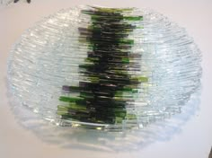 there is a glass plate with green and white strips on it