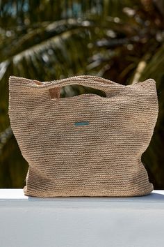 The carry it all bag The Paloma Bag was thoughtfully designed to carry everything you might want for your oceanside tanning session. This bag’s texture instantly elevates any outfit and can effortlessly transition from sand to city in a blink of an eye.Features:Hand crocheted of natural grass yarnsLight weightGold logo Sand-colored Travel Bags For Beach Season, Eco-friendly Shoulder Bag With Rolled Handles For Travel, Versatile Natural Hobo Tote Bag, Versatile Tote Hobo Bag For The Beach, Versatile Hobo Tote Bag For Vacation, Versatile Natural Hobo Bag For Everyday, Versatile Everyday Natural Hobo Bag, Versatile Beach Hobo Bag With Large Capacity, Beach Bucket Bag With Top Handle And Removable Pouch