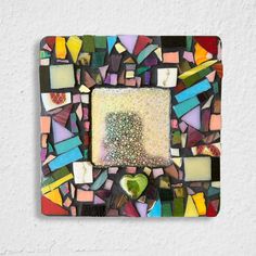 a multicolored mosaic tile with a heart in the center and a white background