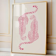 a pink and white print with two cheetah's in the middle on a wall