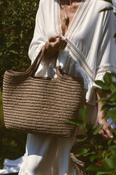 Handmade Crochet Tote Bag, expertly crafted using luxurious raffia yarn. With its generous dimensions of 47*35*15 cm, this bag epitomizes both style and convenience. Rest assured, only the finest quality raffia yarn has been selected, an eco-friendly material created from recycled viscose cellulose.  This high-grade yarn ensures the durability and longevity of your tote, making it a versatile accessory that can be enjoyed throughout the seasons. Whether you're treating yourself or searching for Summer Travel Crochet Bag With Weaving Detail, Summer Travel Crochet Bag, Summer Travel Crochet Weaving Bag, Summer Beach Bag With Weaving For Everyday Use, Summer Travel Bag With Weaving, Summer Travel Bags With Weaving, Summer Beige Bag With Weaving Detail, Summer Beige Woven Bag, Casual Natural Color Bags With Weaving