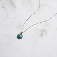 Step into the elegance of a bygone era with our Vintage Turquoise Oval Necklace , a stunning piece that marries timeless design with exquisite craftsmanship. This necklace features an intricately detailed oval pendant, crafted from 925 Sterling Silver and adorned with a striking turquoise centerpiece. The vibrant turquoise, with its signature blue-green hue and natural veining, is surrounded by delicate scrollwork and sparkling zircon accents, adding a touch of refined brilliance to the piece.   The Vintage Turquoise Oval Necklace  elevates your ensemble with its unique blend of classic beauty and contemporary sophistication, making it a must-have addition to any jewelry collection. DETAILS Plating: Oxide Silver Materials: 925 Sterling Silver , Turquoise, Zircon Measurements: Length: 17.71 Elegant Turquoise Necklace With Oxidized Finish, Turquoise Round Locket Jewelry, Round Turquoise Locket Jewelry, Bohemian Engraved Turquoise Necklaces, Turquoise Engraved Round Pendant Jewelry, Engraved Turquoise Round Pendant Jewelry, Vintage Turquoise Necklace With Round Pendant, Antique Turquoise Oval Necklace, Antique Oval Turquoise Necklace