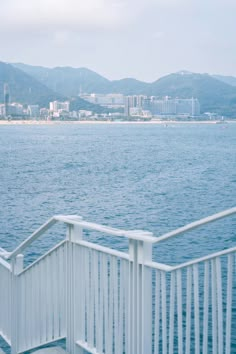 a white railing on the side of a body of water