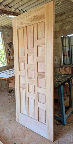 a wooden door is open in an unfinished room