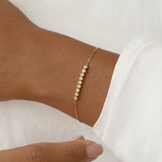 The Maelie Bracelet features a row of 9 bezel-set diamonds on a dainty 14k yellow gold chain. 

Versatile and elegant, this bracelet will elevate any look.


9 lab grown diamonds, each with a width of 2mm 

Total carat weight: 0.27 

14k yellow gold 


Bracelet can be worn between 5.75” and 7” (fitting wrists with circumference ~5.25” to 6.75”) Fine Bracelet, Ring Redesign, Delicate Gold Bracelet, Minimal Bracelet, Bezel Bracelet, Cute Engagement Rings, Diamond Necklace Designs, Silver Jewelry Design, Bezel Set Diamond