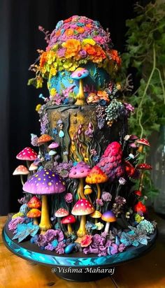 there is a colorful cake that looks like mushrooms and other things on the top of it