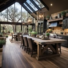 a large dining room table surrounded by lots of chairs and tables in front of windows