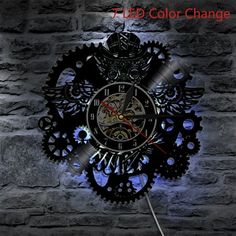 a clock made out of gears on a brick wall with the words 7d color change